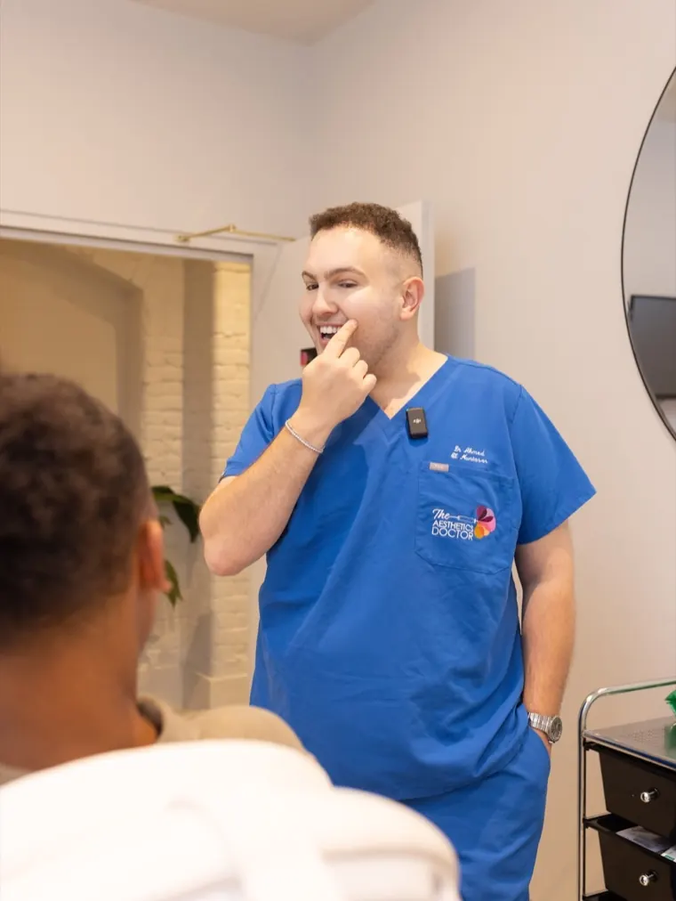 Dr Ahmed with a patient in the treatment room